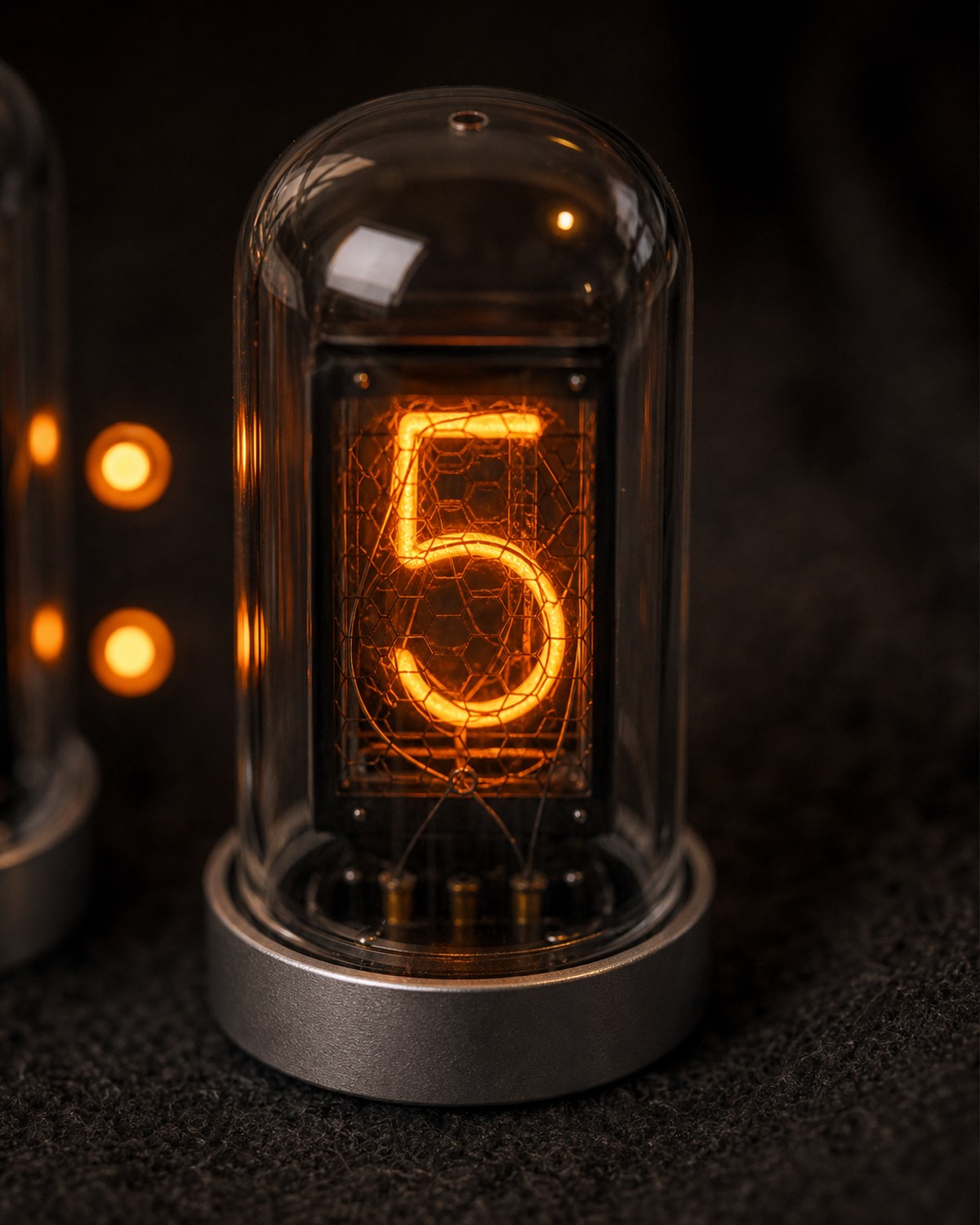 Nixie tube clock digit close-up with orange halo detail.
